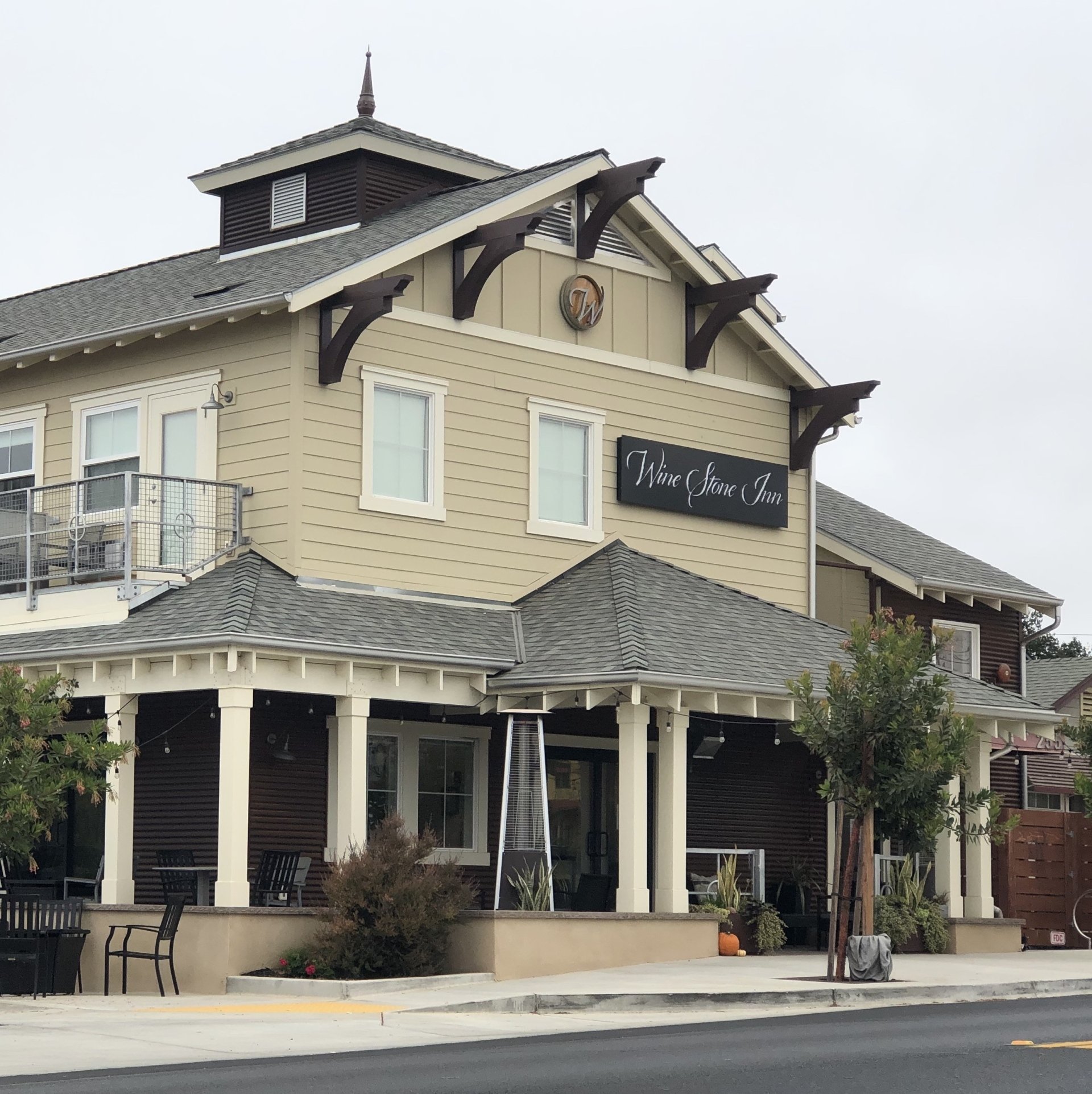 The Wine Stone Inn by day, with its hanging sign and covered porch